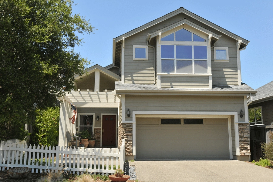 nice single-family home with a front porch and white fence